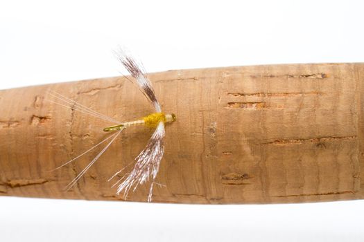 This fly fishing imitation shows two wings and plenty of detail for this fly hooked onto the cork handle of the fly rod.