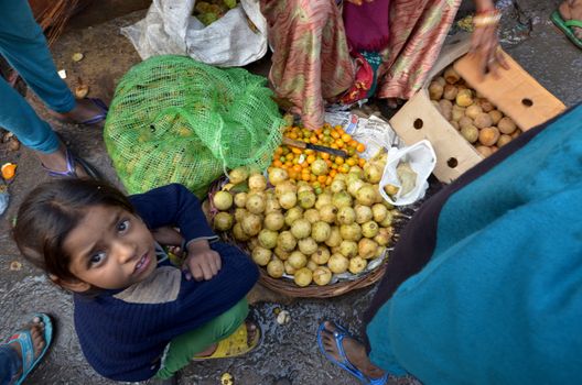 New Delhi,India-February 4, 2013:An unidentified child sell fruit in a  market in New Delhi in February 4,2013 the food market in New Delhi is the largest one in India.