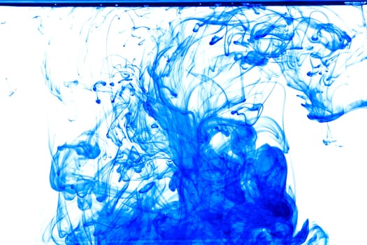 Blue ink isolated dissolving in water