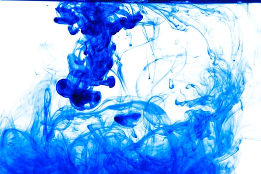 Blue ink isolated dissolving in water