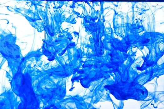 Blue ink isolated dissolving in water