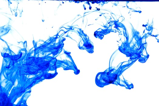 Blue ink isolated dissolving in water