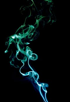 Blue and green abstract smoke on black