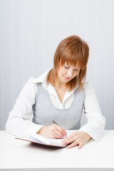 Attractive girl with a notepad and pen