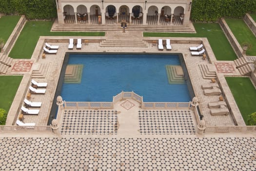 Swimming pool set in in Mughal style landscaped gardens. Luxury Hotel, Agra, India