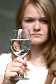 Girl with a glass of water looking at the camera