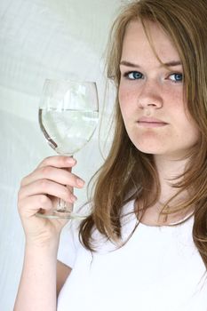 Girl with a glass of water looking at the camera