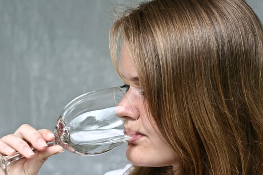 Girl with a glass of water looking at the camera