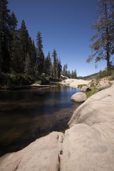 Flowing river in the spring with a blue sky anclear water