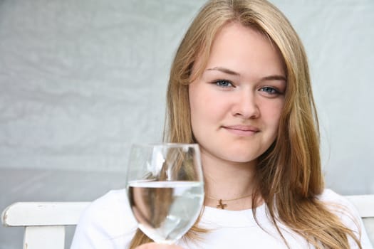 Girl with a glass of water looking at the camera
