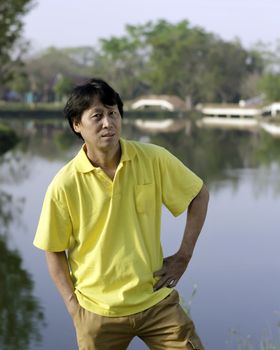 A portrait of a senior south asian man by lake