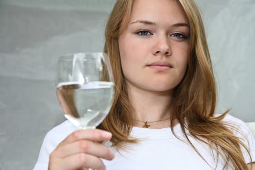 Girl with a glass of water looking at the camera