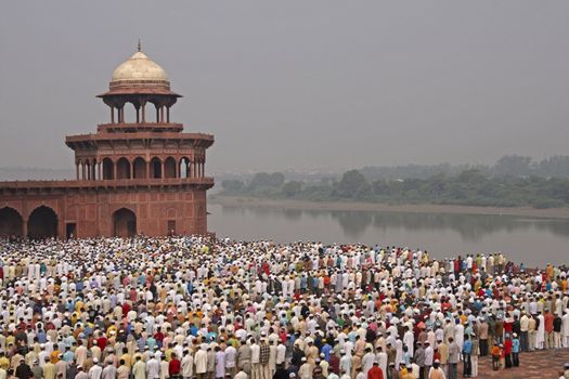 Thousands of people gather in front of the mosque at the Taj Mahal to celebrate the Muslim festival of Eid ul-Fitr in Agra, Uttar Pradesh, India