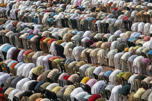 Thousands of people bending in prayer in front of the mosque at the Taj Mahal to celebrate the Muslim festival of Eid ul-Fitr in Agra, Uttar Pradesh, India