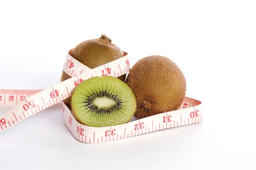 Kiwis slice and tape measure on isolated white