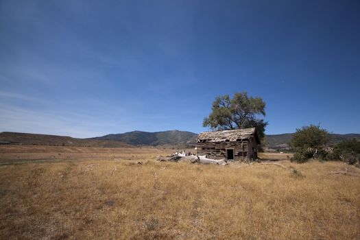 an old abandoned barn in an open field