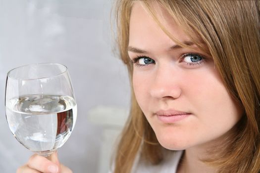 Girl with a glass of water looking at the camera