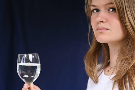 Girl with a glass of water looking at the camera