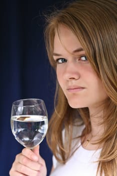 Girl with a glass of water looking at the camera