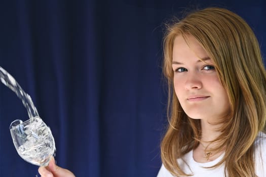 Girl with a glass of water looking at the camera