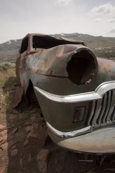 Old abandoned car with bullet holes. Reno Nevada high desert