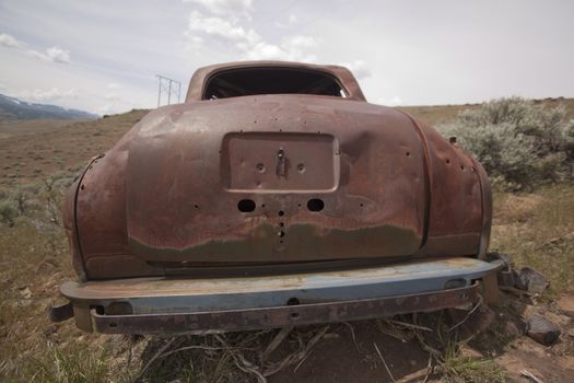 Old abandoned car with bullet holes. Reno Nevada high desert