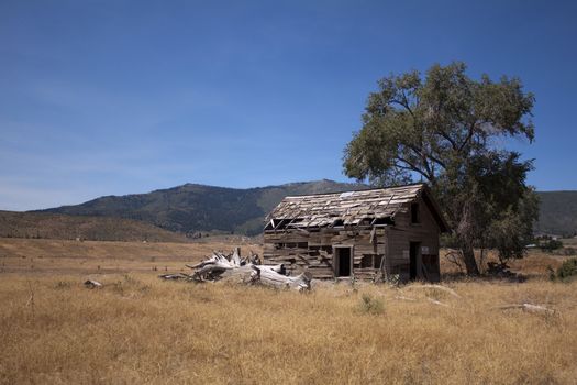 an old abandoned barn in an open field
