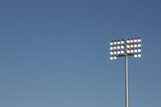 Stadium lights on a blue sky background. could be used for football, soccer, baseball, etc.