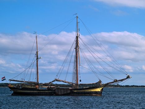 Classical traditional Dutch old fashion sail boat by the port