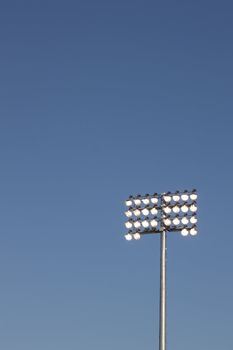 Stadium lights on a blue sky background. could be used for football, soccer, baseball, etc.