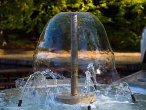 Closeup view of a decorative garden water fountain with effect of frozen flow