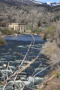 Flowing river in the spring with a blue sky anclear water