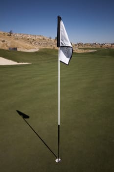 Golf course with green grass and clear blue skies.