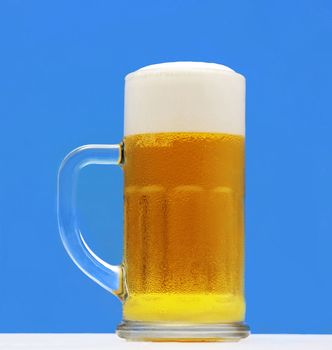 Beer glass on a blue background. With Clipping Path.