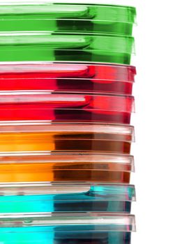 Stack of colorful Petri dishes isolated over white background