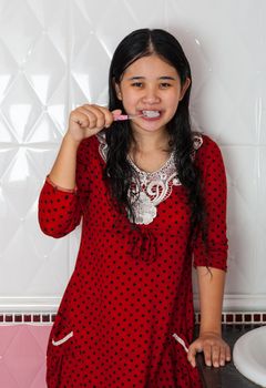 Cute Asian-Thai Girl is brushing her teeth