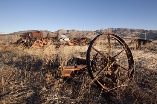 old rusty farm equipment in the middle of a field