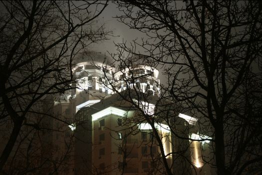 Black silhouettes of trees are seen against the castle