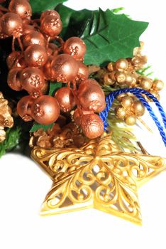 Gold metalic star with berry Christmas floral isolated on the white.