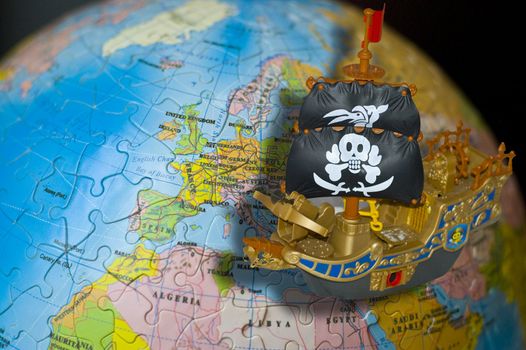 Classic Pirate Ship Sailboat on the Puzzle Globe 
Background.