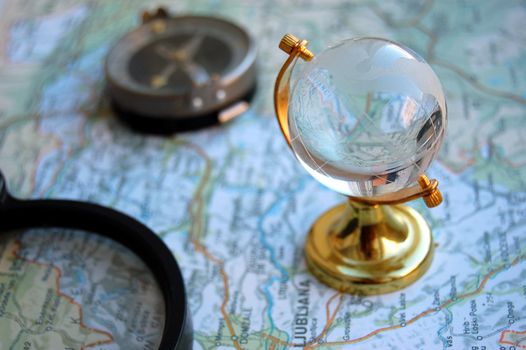 Map, globe and magnifying glass