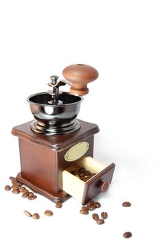 Coffee grinder with beans isolated on white