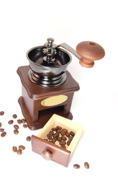 Coffee grinder with beans isolated on white