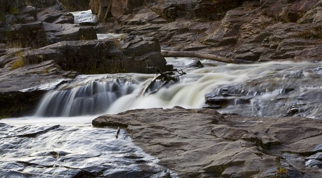 Creek flows through a stone channel in northern Minnesota in November