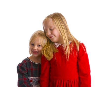 Sisters in Christmas dresses ready for a formal holiday occasion