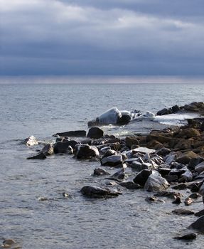 The icy north shore of lake Superior with Rain on the Horizon