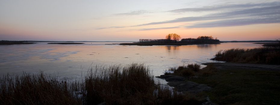 Frozen Wild Rice Lake at twilight in November in the North woods of Minnesota