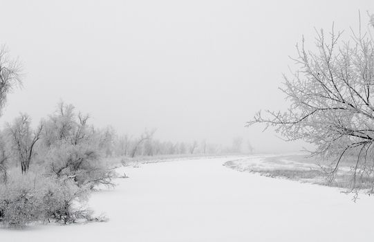 The James river in South Dakota on a frosty and foggy winter morning.