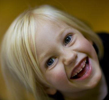 Laughing girl looking up at the camera