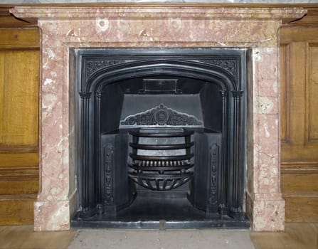 Ancient fireplace in room castle (decorated by an ornament on iron and fixed by a marble) 1700-1800 job of the Italian masters